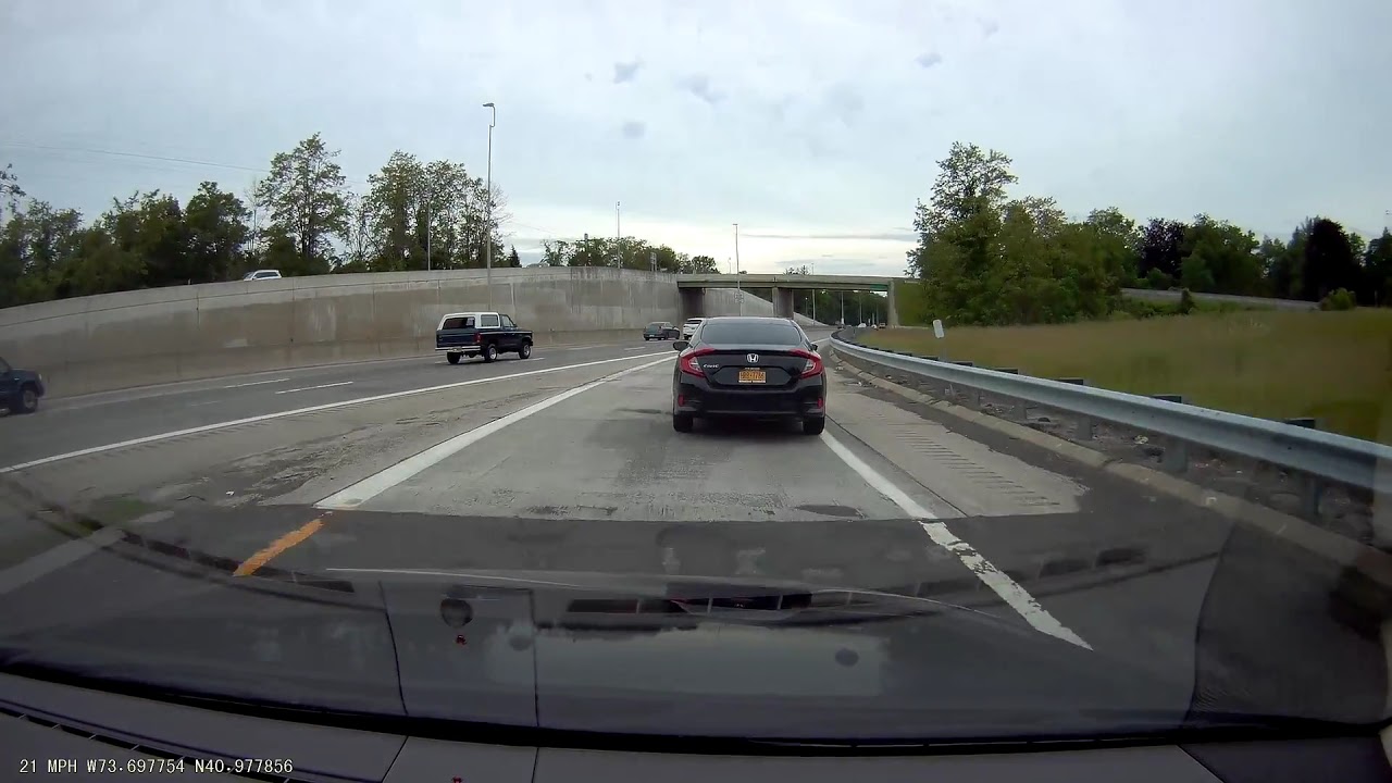 Car brakes on the highway on-ramp, merges at an unsafe speed
