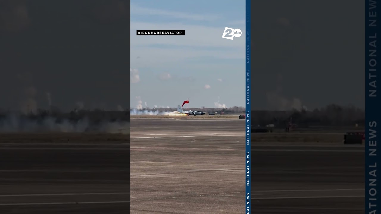 Flames emerge as a NASA jet lands without landing gear at an airport near Houston, Texas
