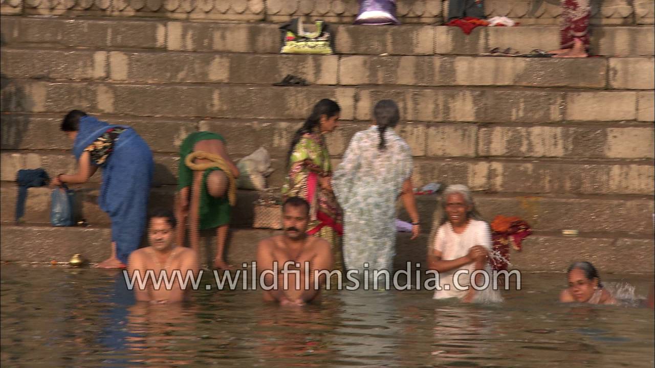 Devotees take holy dip in river Ganga in Varanasi