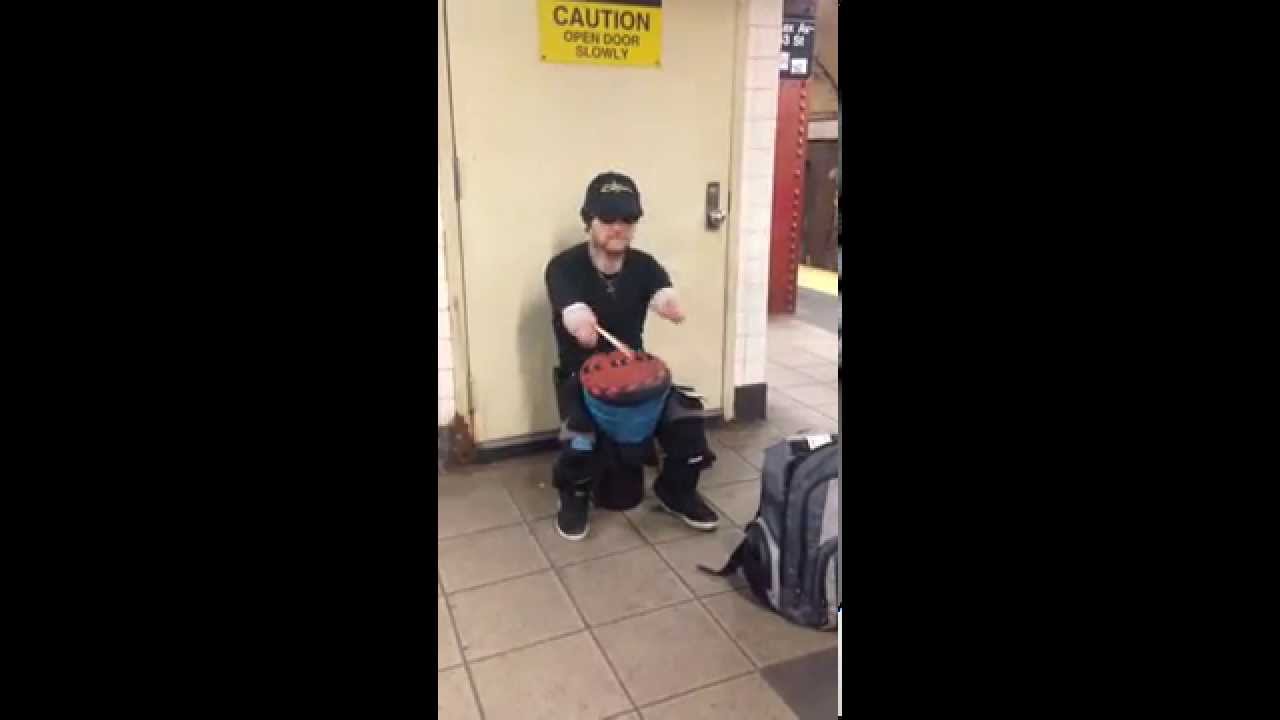 Armless drummer on NYC subway