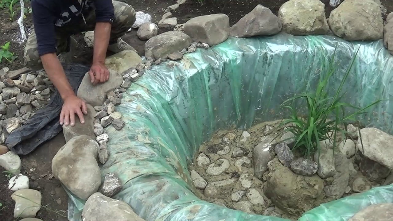 Small pond with waterfall  stones and fish in the garden || The first part