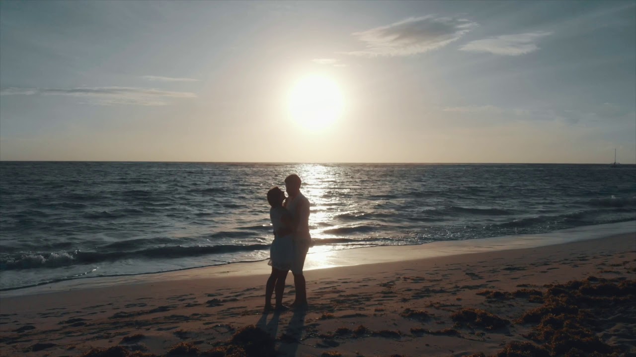 Romantic Happy Couple Walking Hand In Hand On A Beach