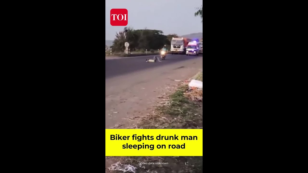 Biker fights drunk man sleeping on road