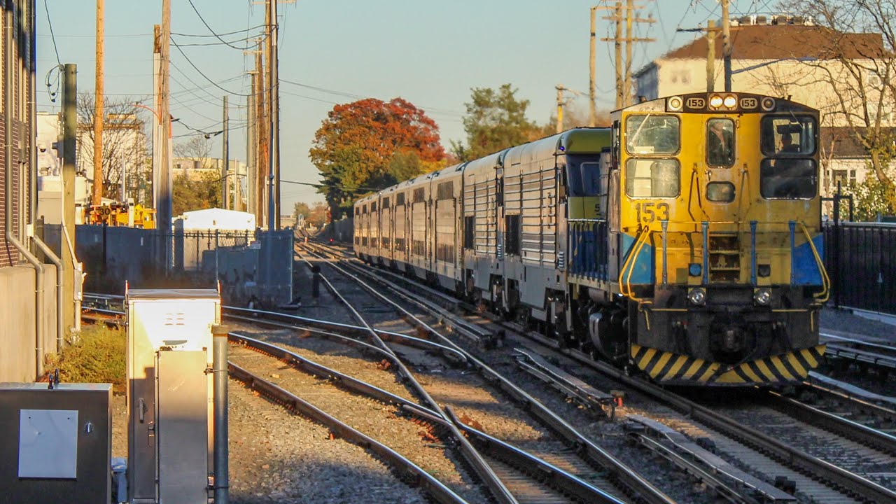 LIRR MP15AC 153 tows a double header through Mineola