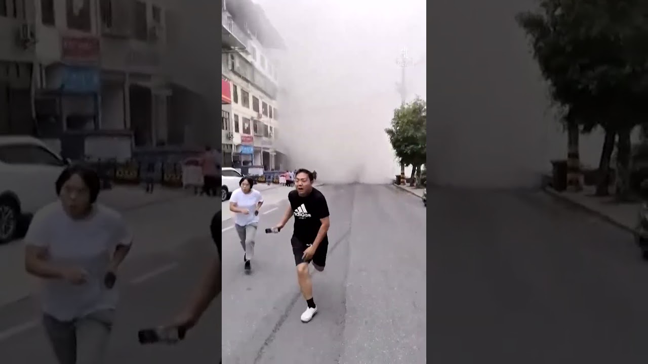 Moment landslide hits road and destroys buildings in China