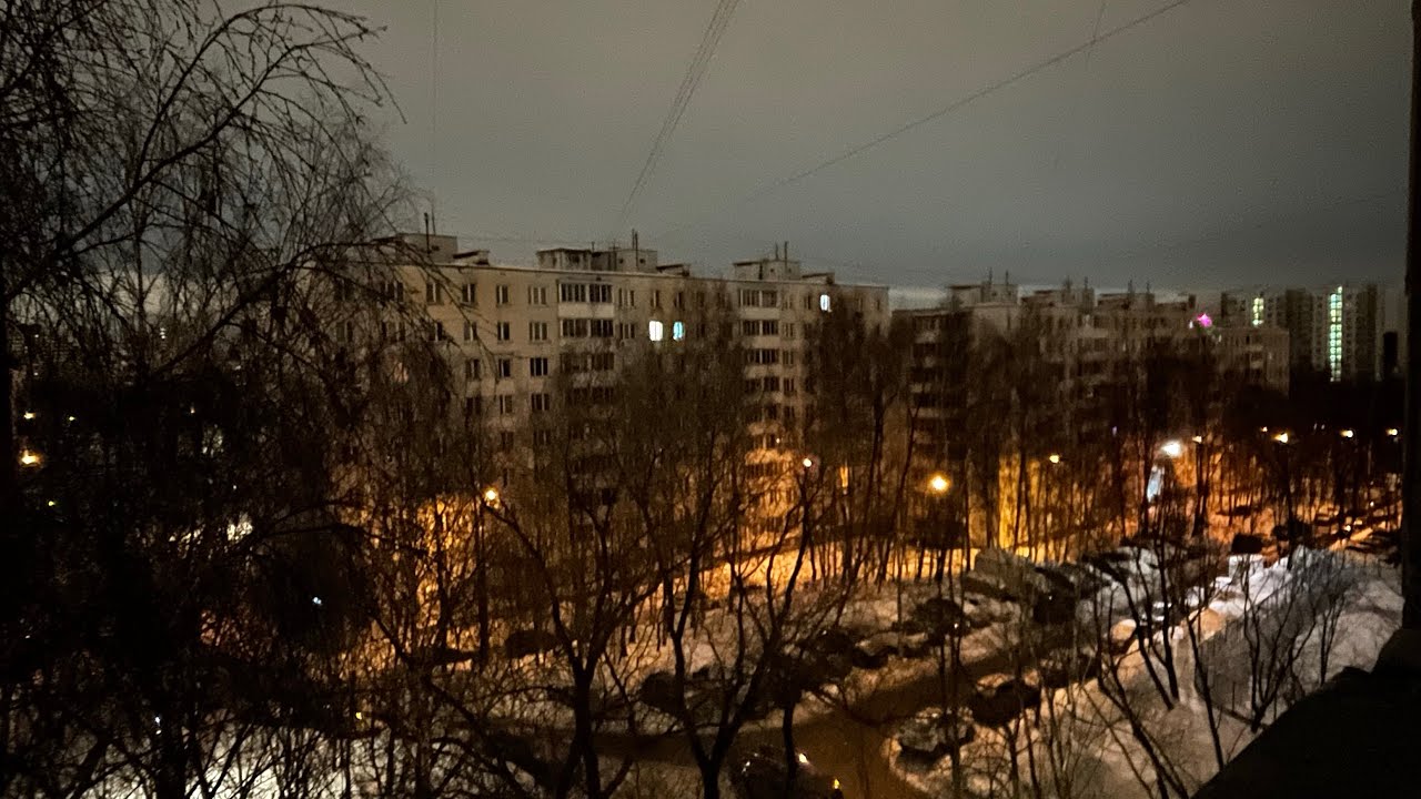 Snow is everywhere: on benches, on rooftops, and on trees.