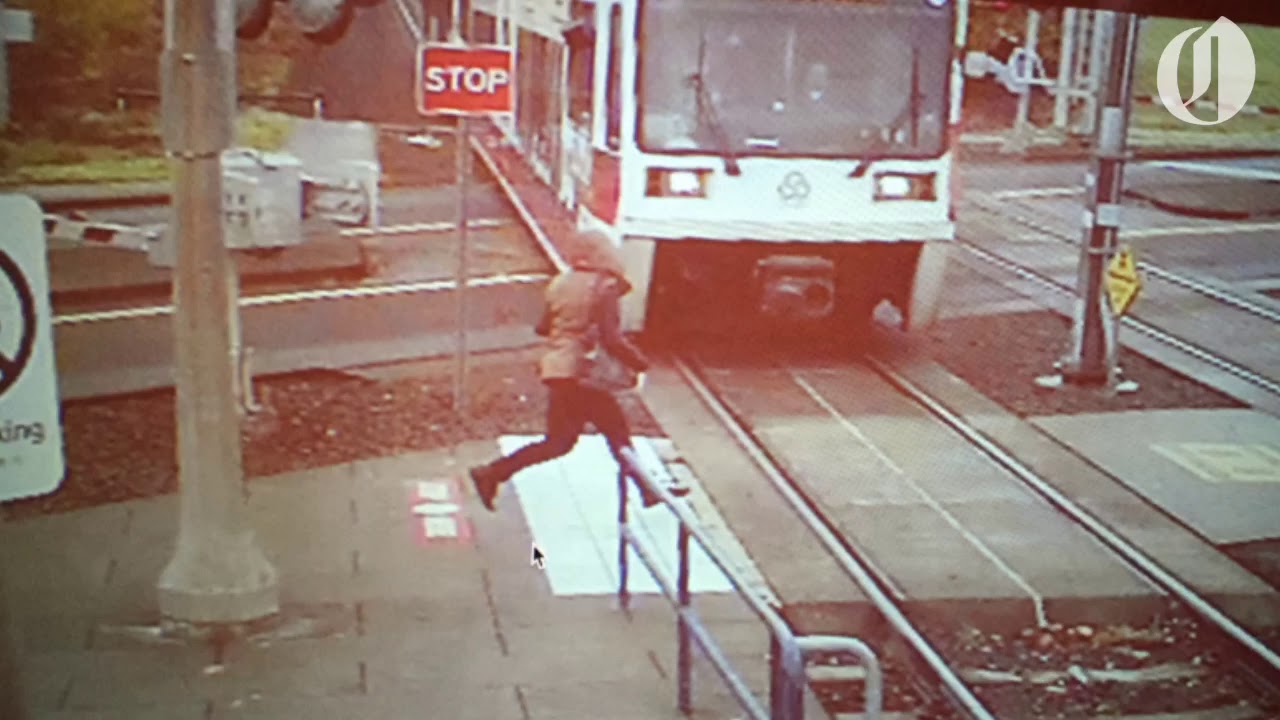 Video shows woman running in front of MAX train