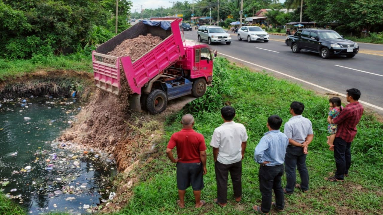 Dump Truck First Starting Unloading Soil And Bulldozer Pushing Soil Into water After 