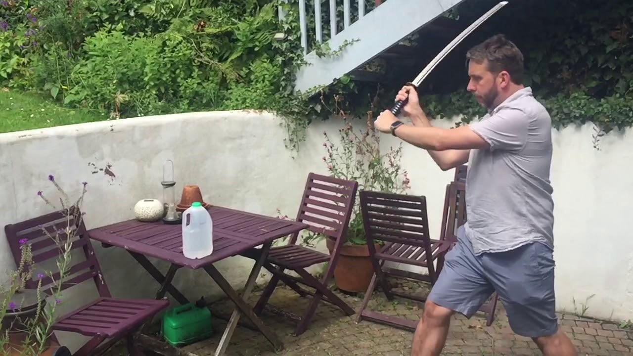 Test cuts on a plastic milk bottle with a sword