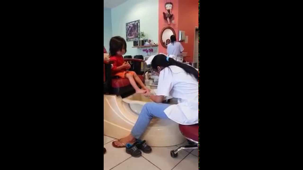 Little boy trying to have a spa pedicure at Nail Salon.