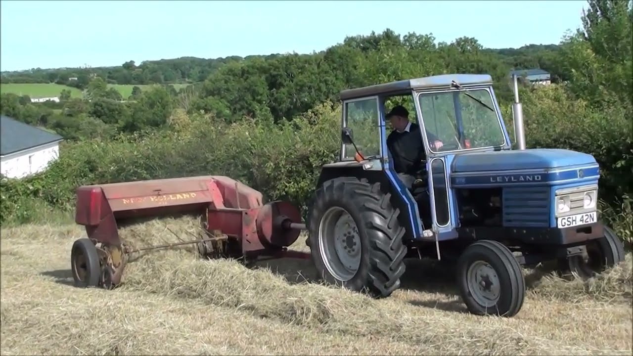1975 Leyland 270 tractor baling hay with a New Holland 68 conventional baler