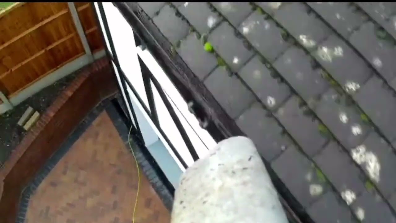 Action footage of gutter clearing gutter cleaning 