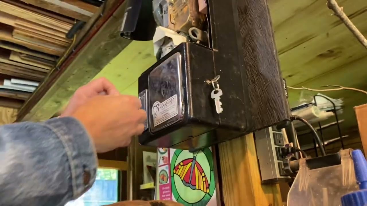 Unlocking a pay phone and accessing the mount screws.