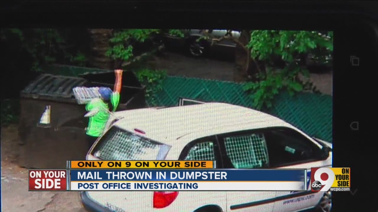 USPS worker throws mail in dumpster