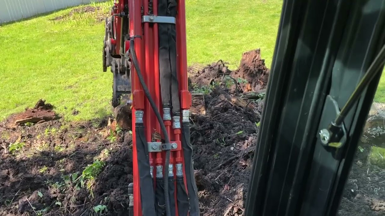 Kubota KX033-4 popping stumps and clearing a yard