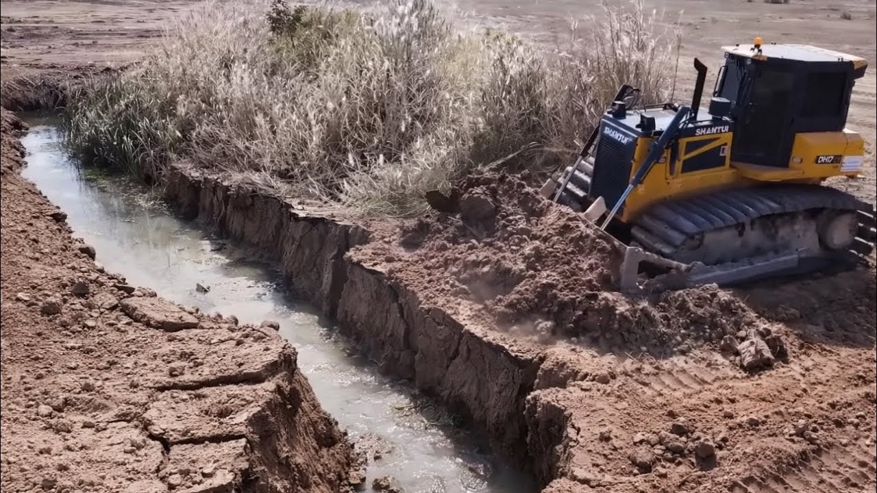 SHANTUI Bulldozer Pushing Sand Bury Some Crack On The Land