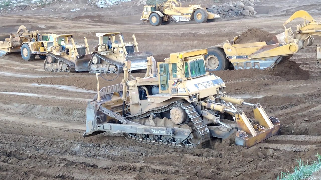 CAT D10N Dozers and 651E scrapers at work - Massive earth moving -