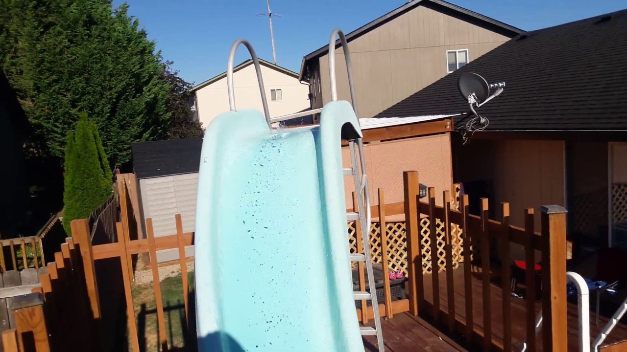 Intex above ground pool 18x9 with a deck, slide and sprayer.