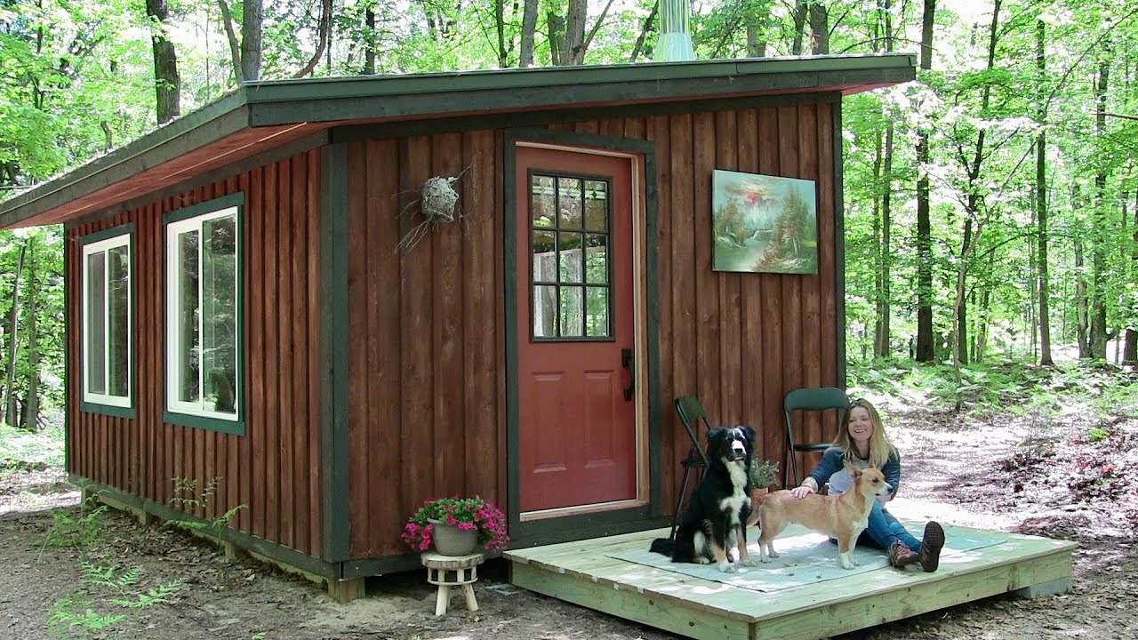 the off grid cabin building a porch and a fire pit