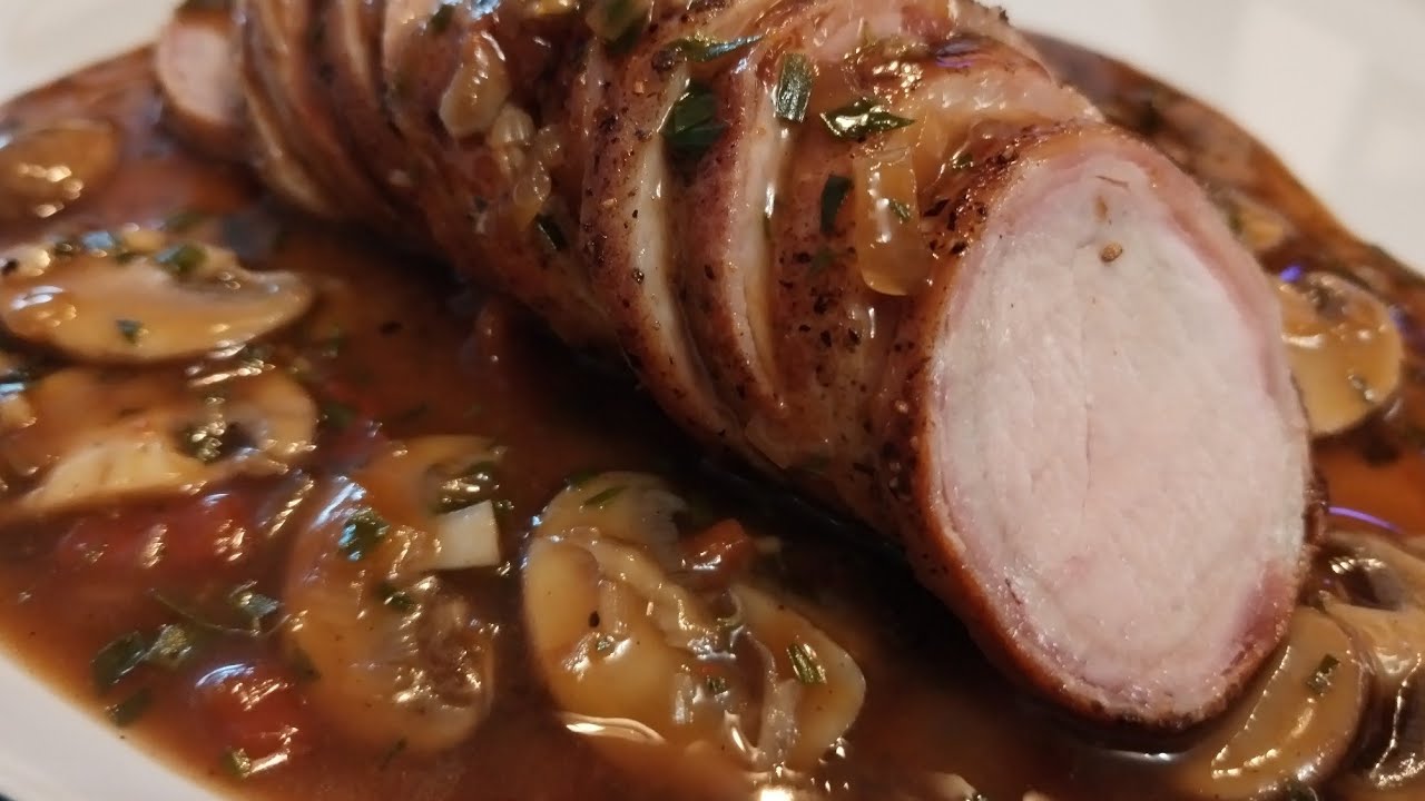 Fillet of pork roasted in bacon with a mushroom and tarragon sauce.