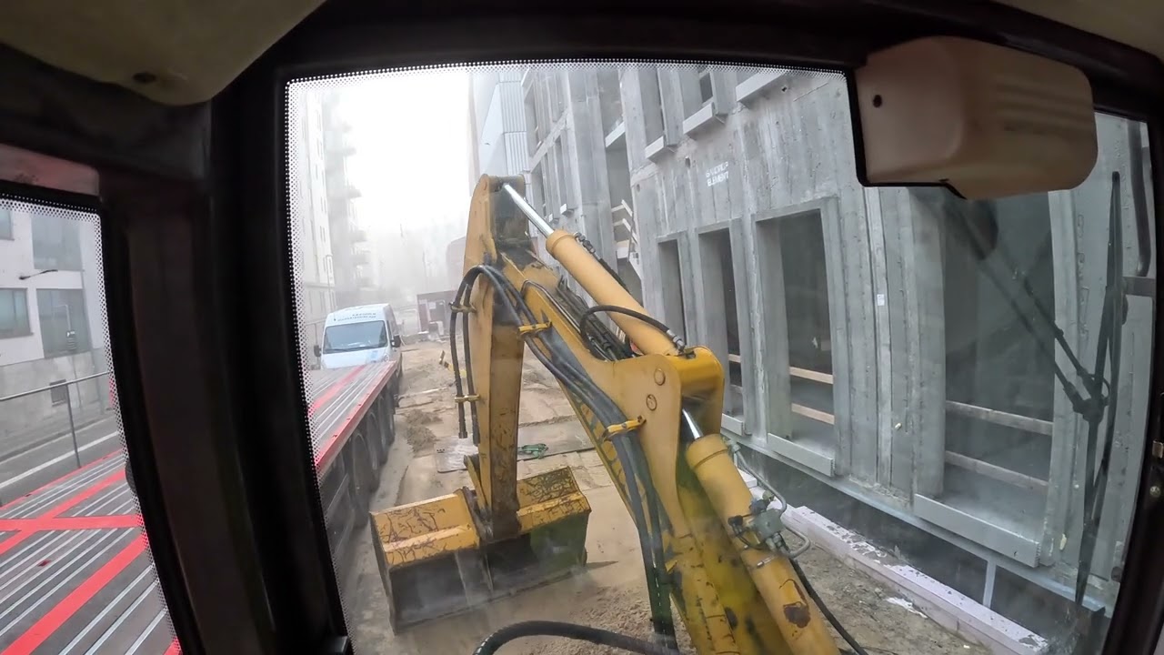 Backfilling around new building with backhoe
