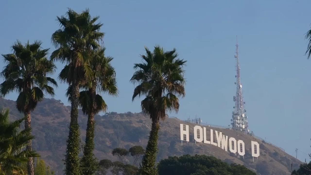 Locals check the Hollywood sign after seeing false reports of the iconic landmark burning