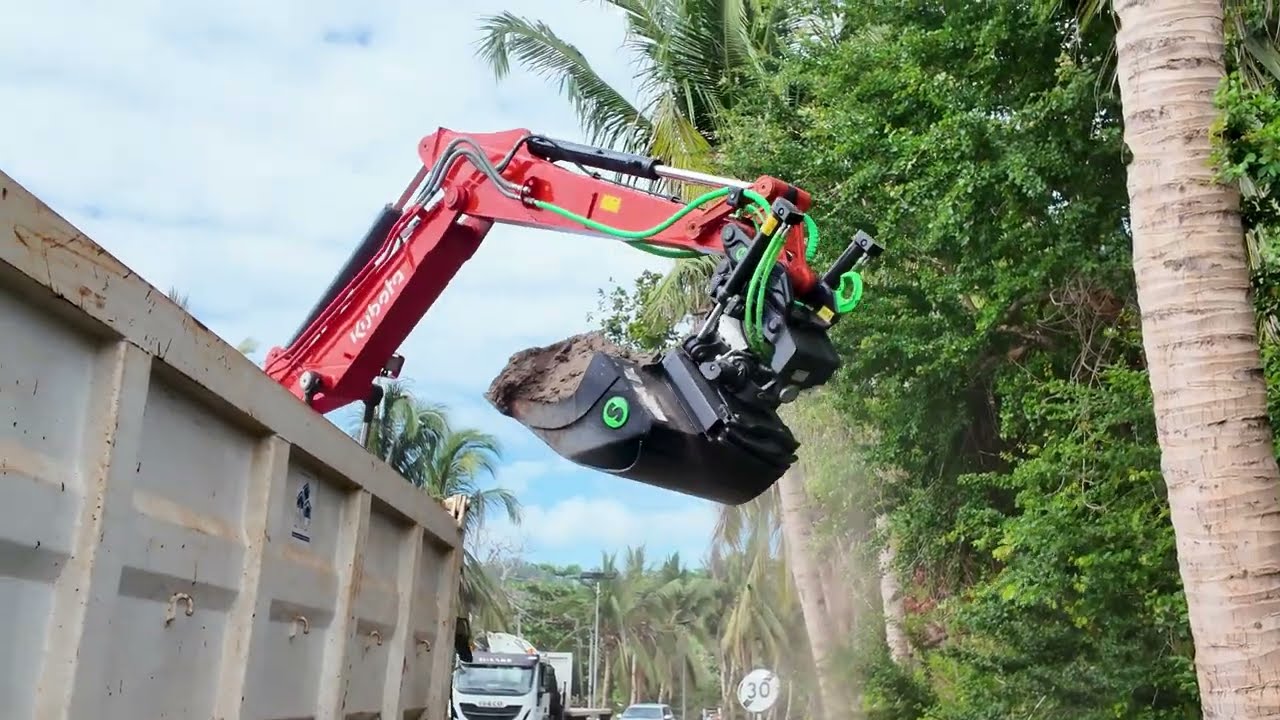 Kubota KX085-5 with a Steelwrist X12 tiltrotator working alongside the road