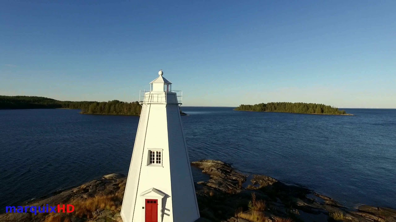 Historic Wooden Lighthouse Overlooking Uninhabited Islands and Rocky Shorelines