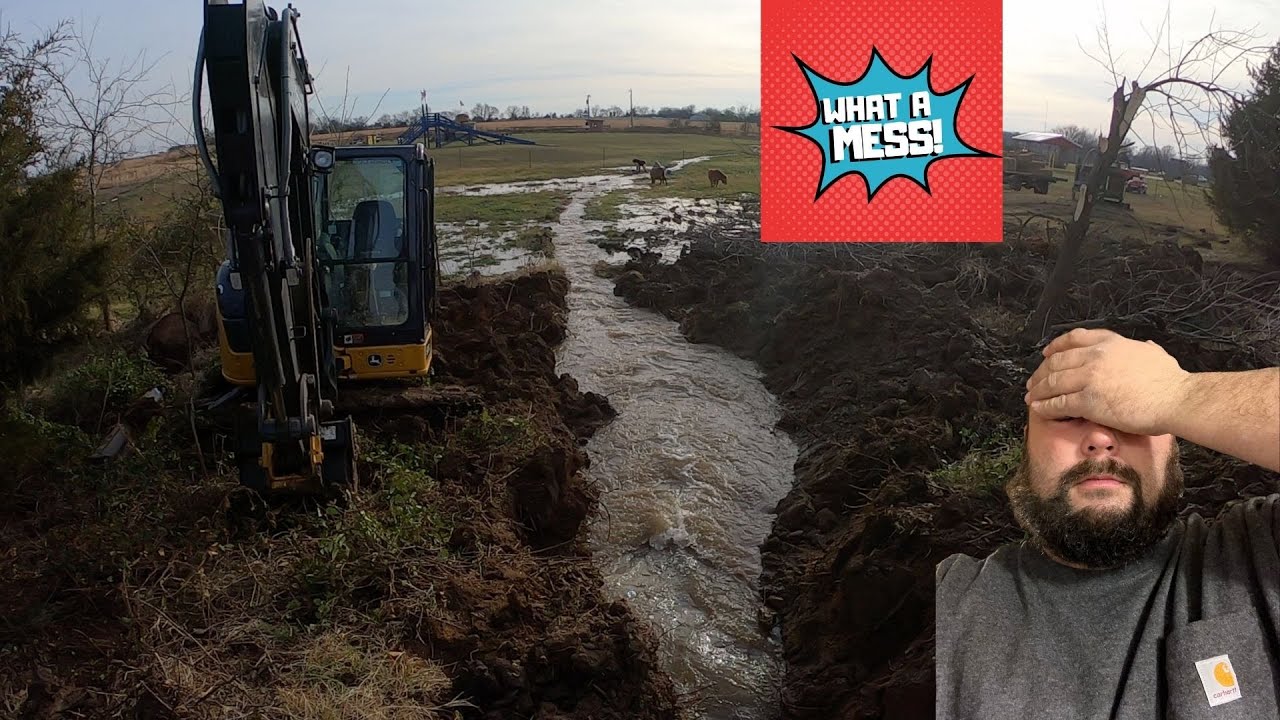 Draining the pond with John Deere 60g excavator.