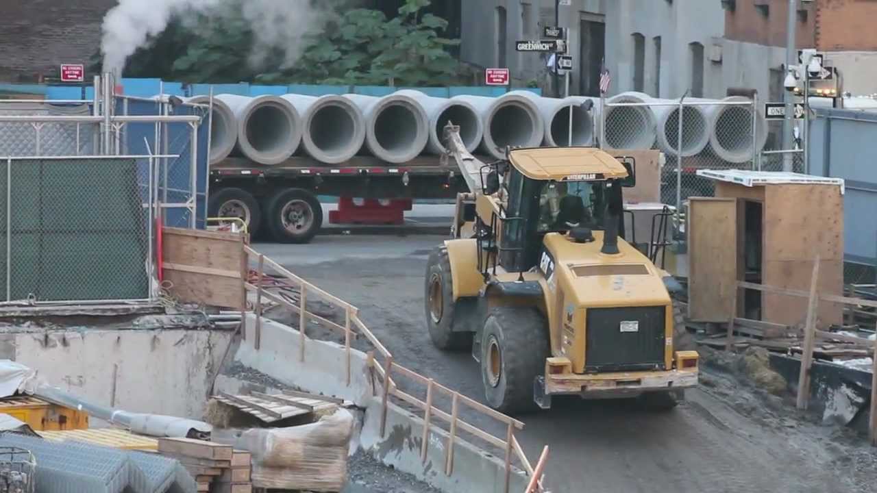 Cat 966H Wheel Loader Unloading Concrete Pipe