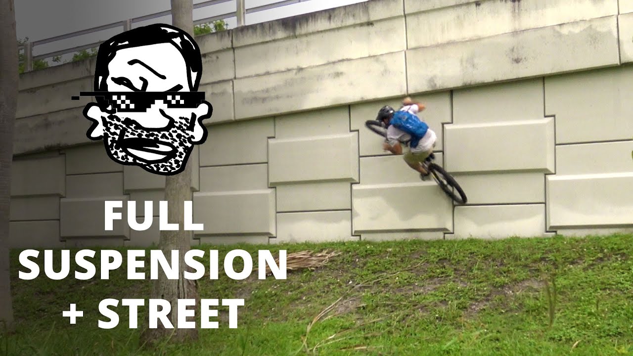 Езда по улице на двухподвесном горном велосипеде