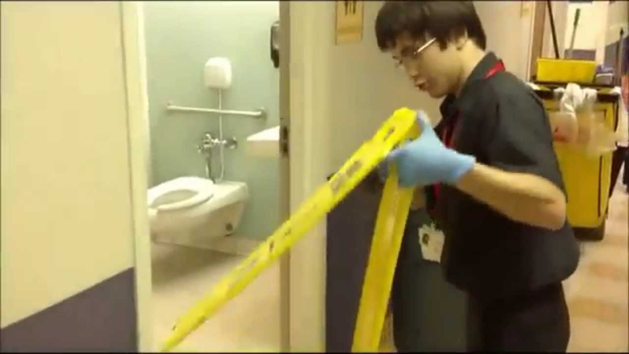 Charlie sanitizing restroom: Project SEARCH internship