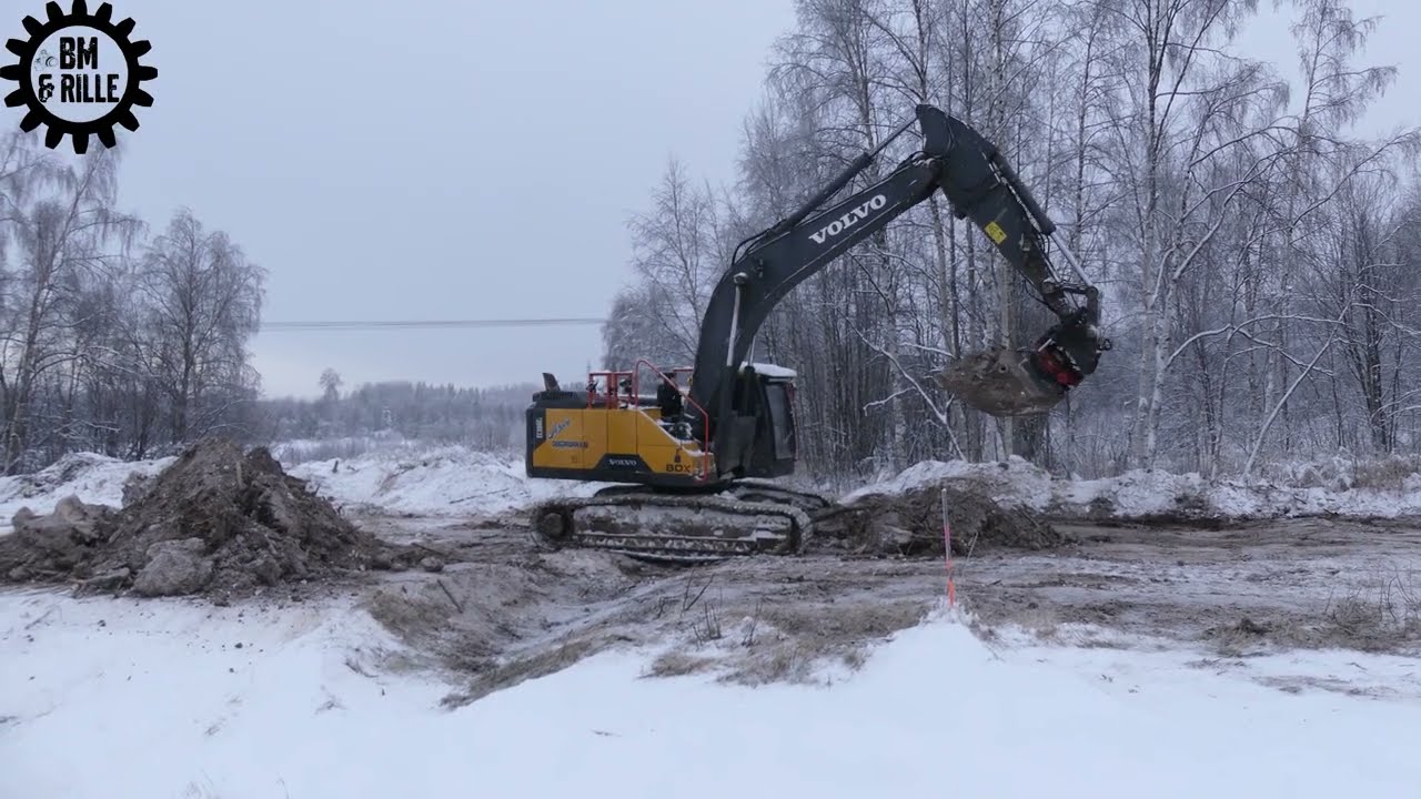 Volvo EC300EL uncover vegetation , loads it on a Scania truck