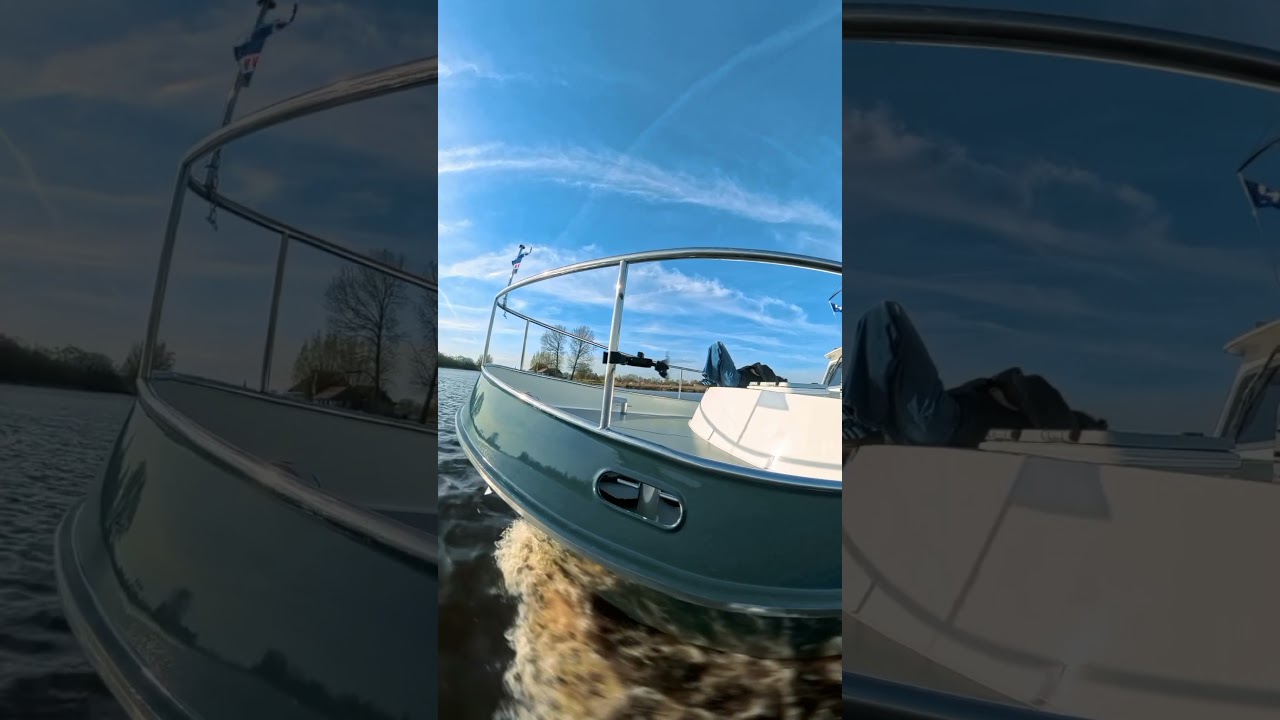 Sailing down canals of Friesland NL on a Simmerskip 1200