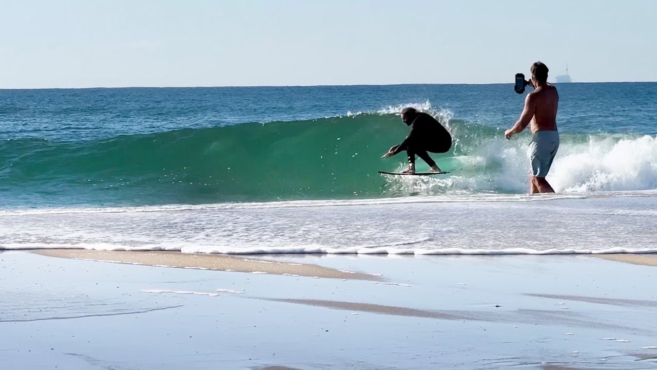 Skimboarder Runs in to Reeling Point Break Wave