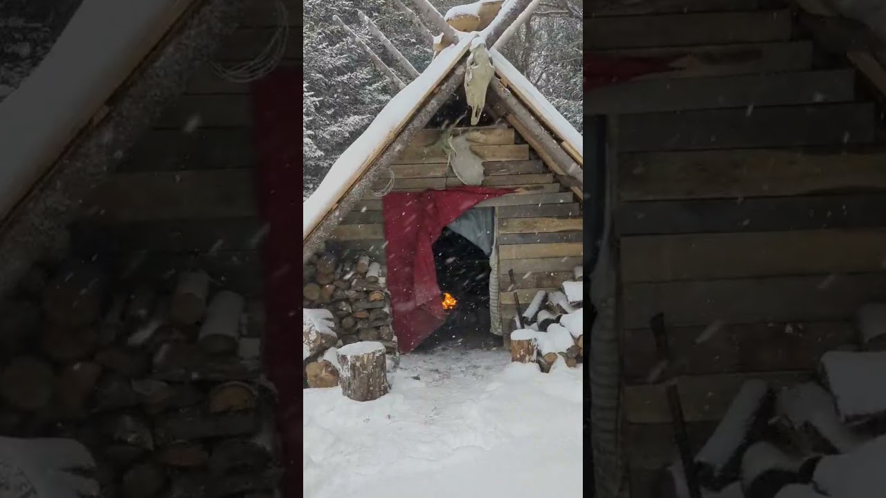 cozy fire during winter storm in my bushcraft shelter