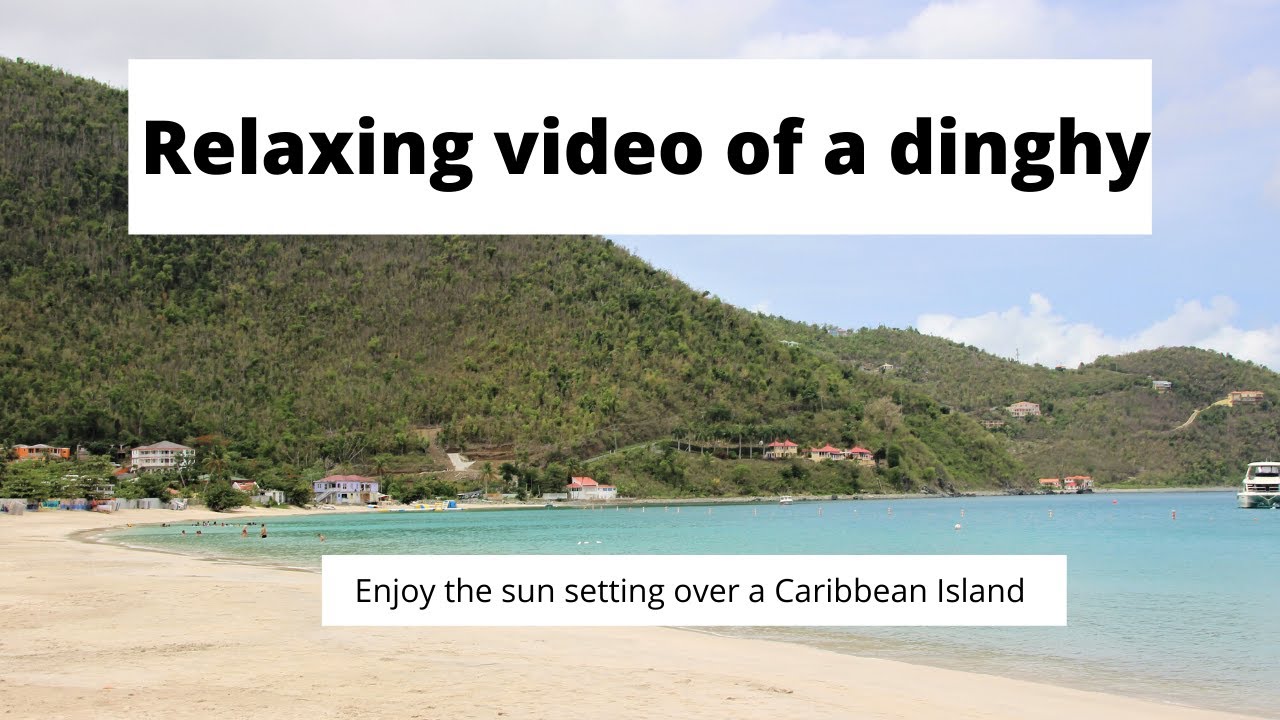 Watch a Dinghy happily floating around as the sun sets on a Caribbean Island