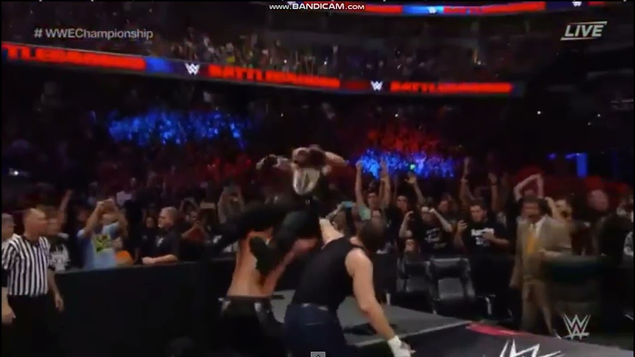 Seth Rollins & Dean Ambrose powerbomb Roman Reigns through Announce table