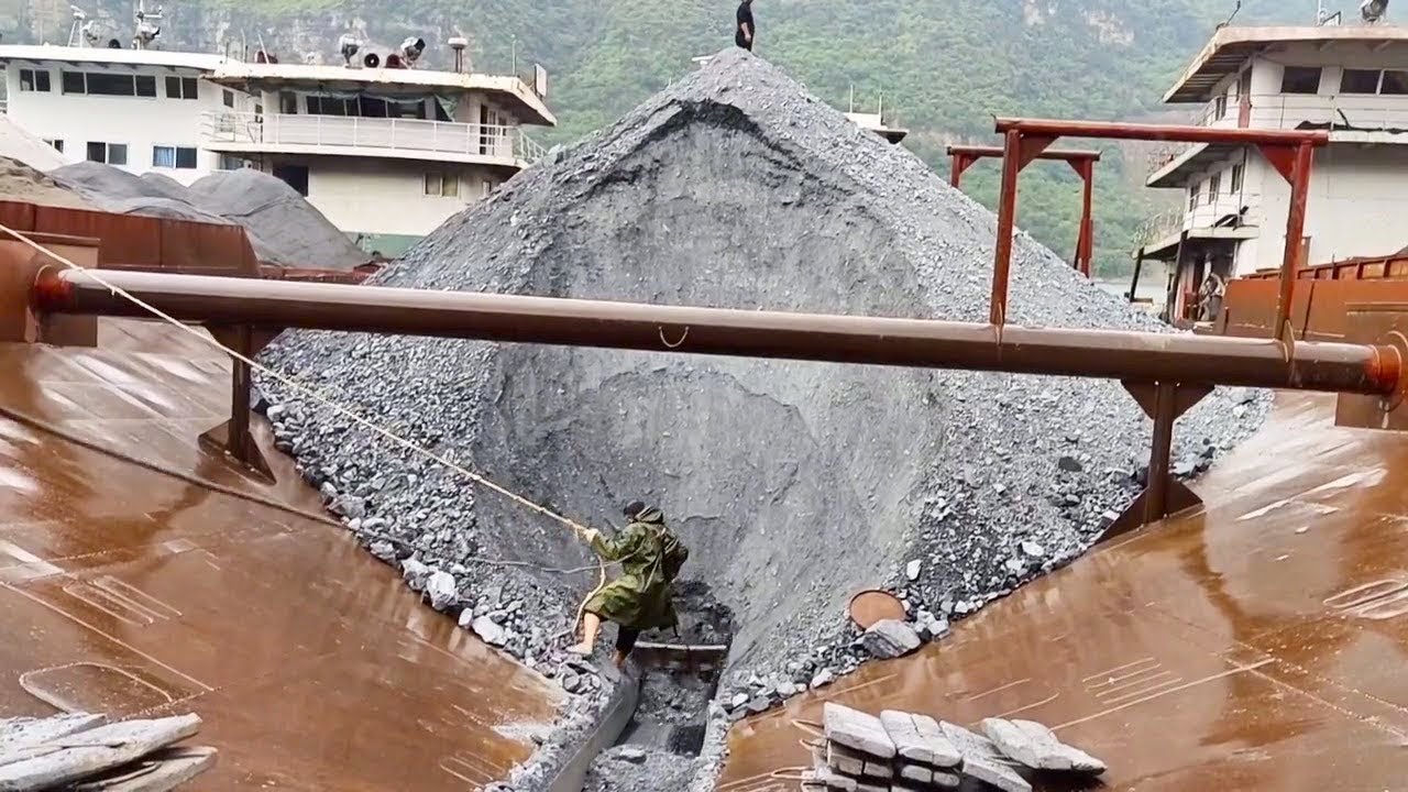 Manual barge unloading, camo guy takes out first board