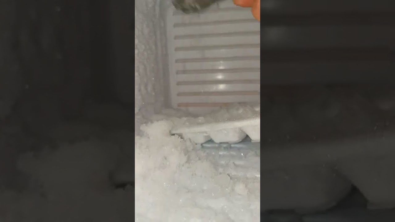ice scrapping with spoon satisfying noise. white ice crystal ice freezer frost ice