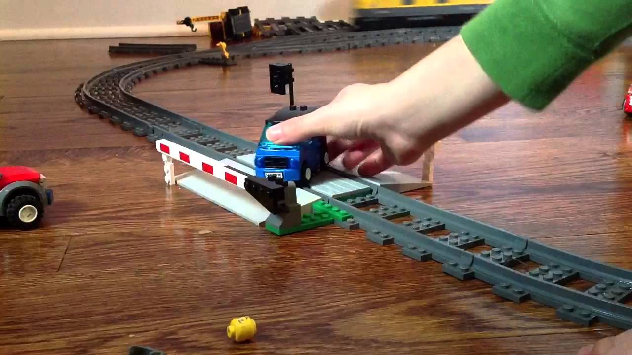 Lots of lego cars get crashed by lego train.