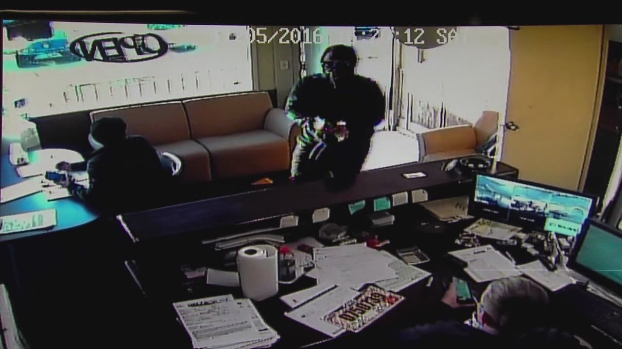Armed robber holds two men up at a Cleveland car dealership, shoots at one of them