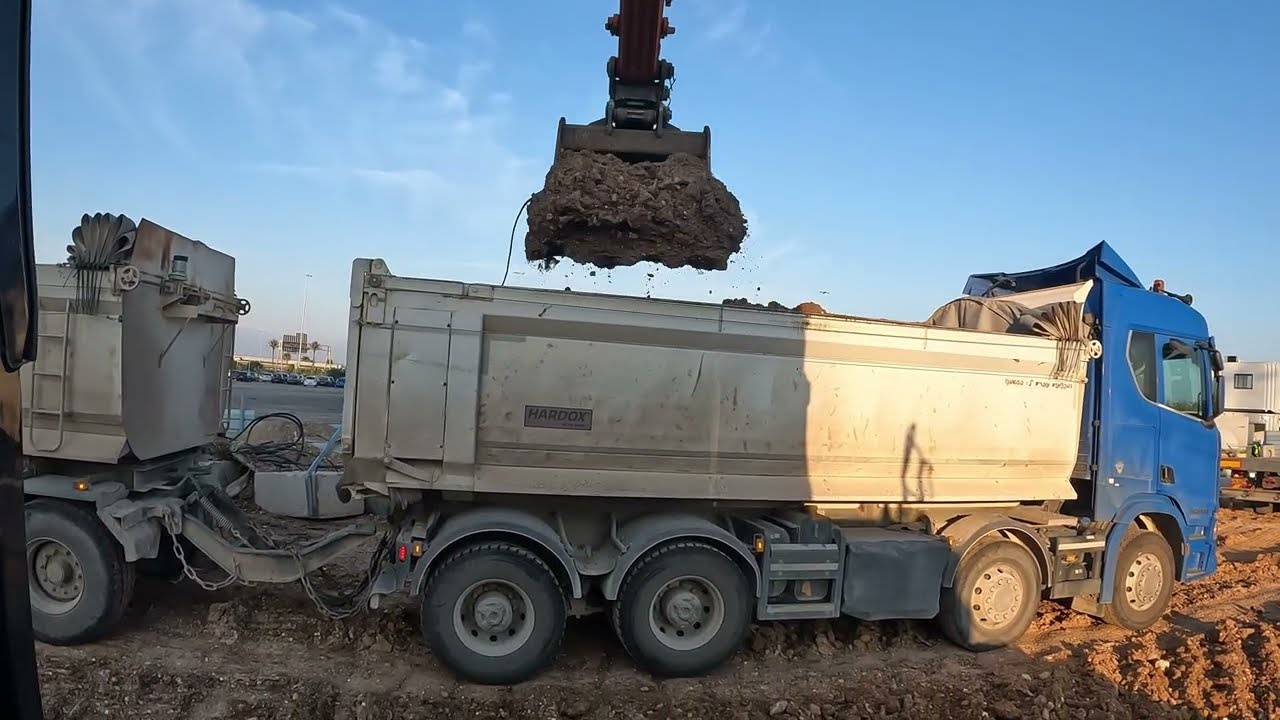 Title: Hitachi Excavator Loading Dirt into a Truck – Powerful Machine in Action!