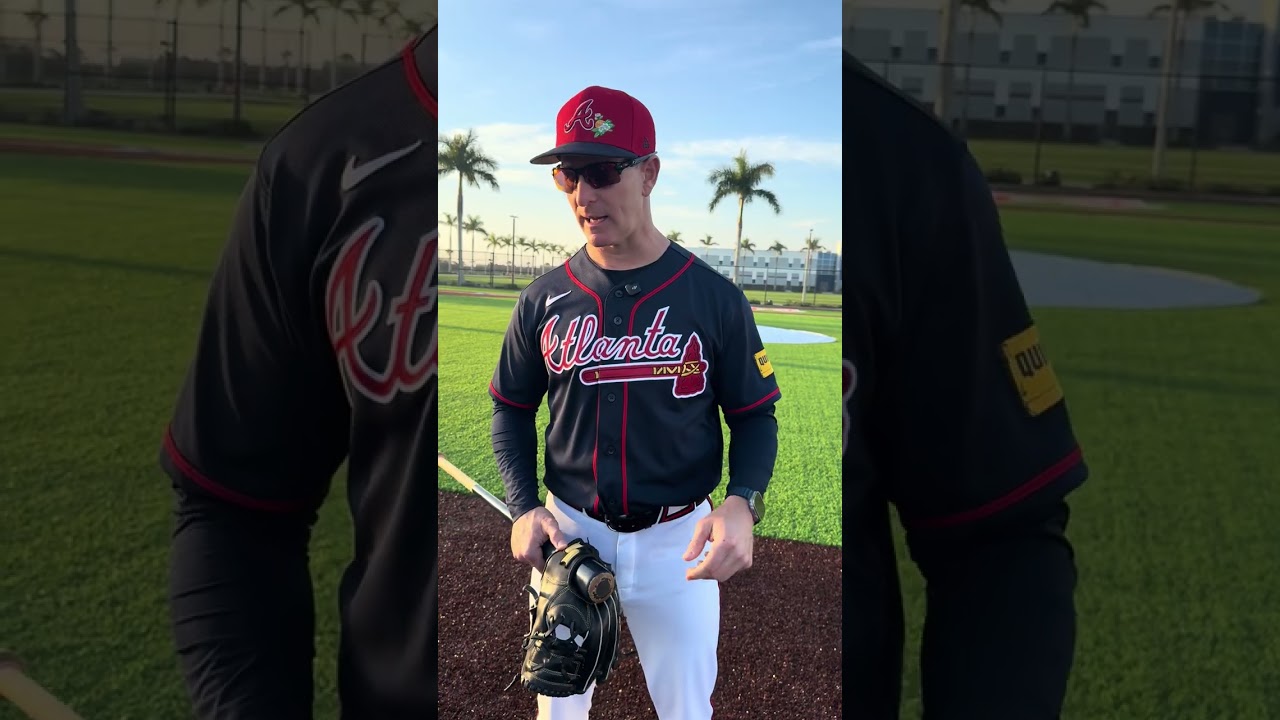 Braves bench coach Tony Mansolino walks the bases with Chris Dimino 