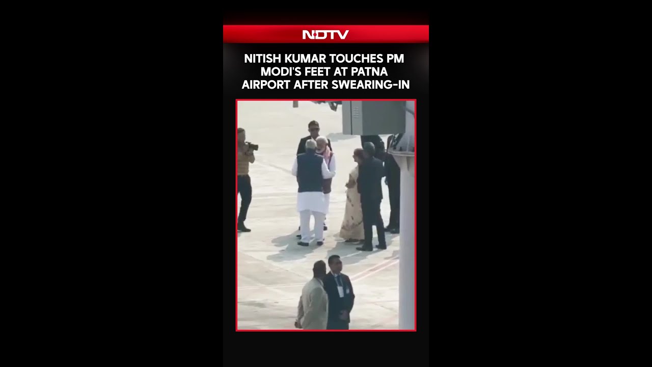 Nitish Kumar Touches PM Modi's Feet At Patna Airport After Swearing-In