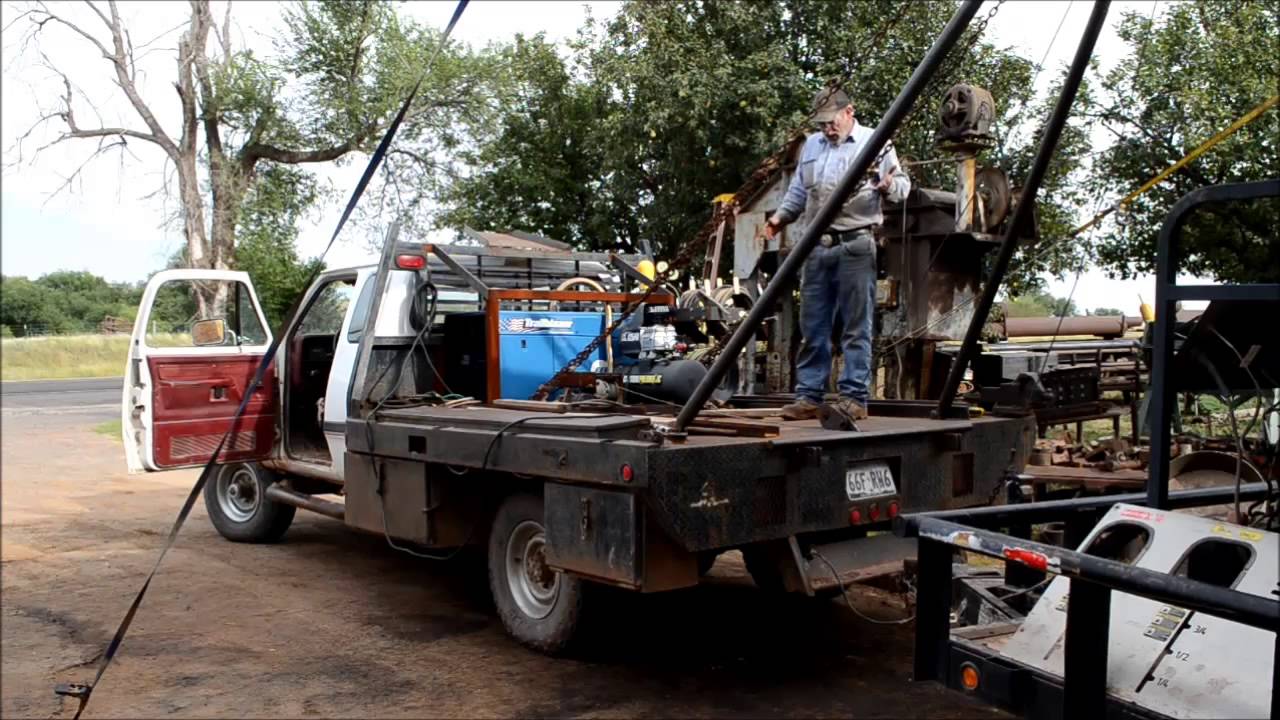 Raising the poles on a small winch truck.