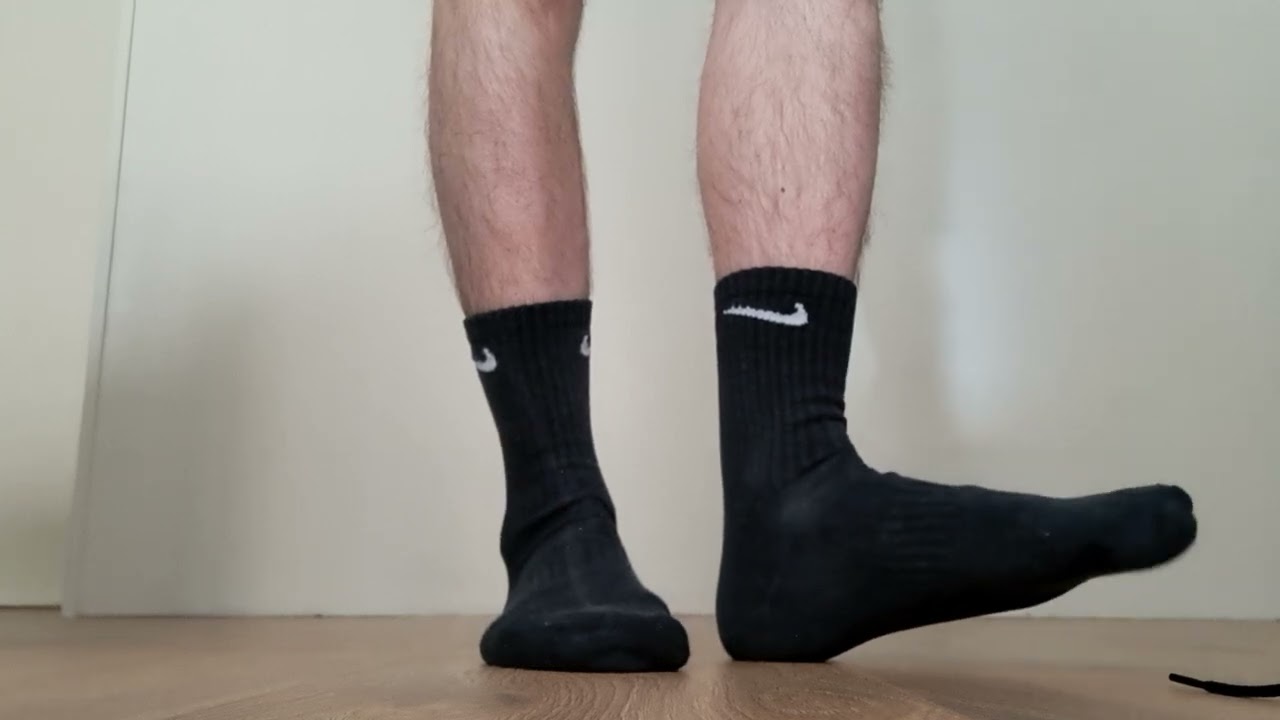 Nike TNs, black socks, slides and bare feet