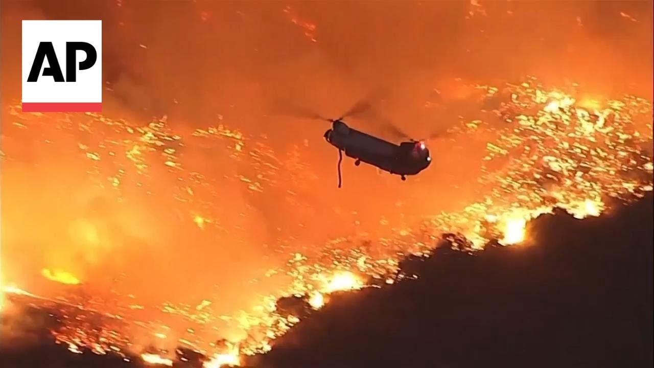 Helicopters battle flames as Palisades Fire burns on Santa Monica Mountains