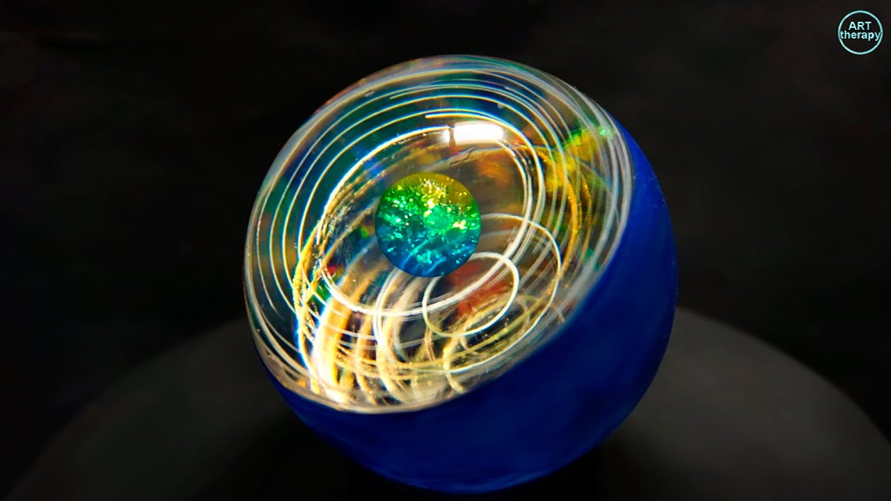 Resin sphere. Rings with acrylic paints in an epoxy resin sphere. Epoxy resin