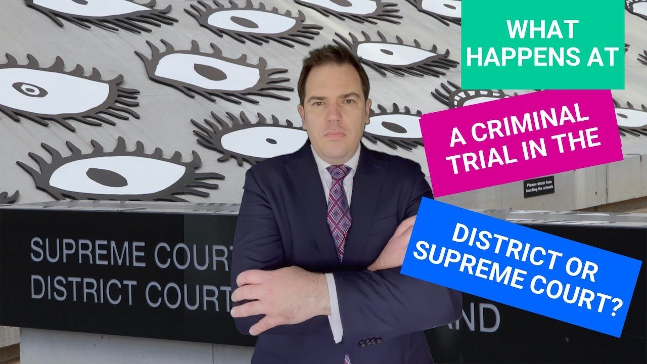 What happens at a criminal trial in the District or Supreme Court of Queensland?